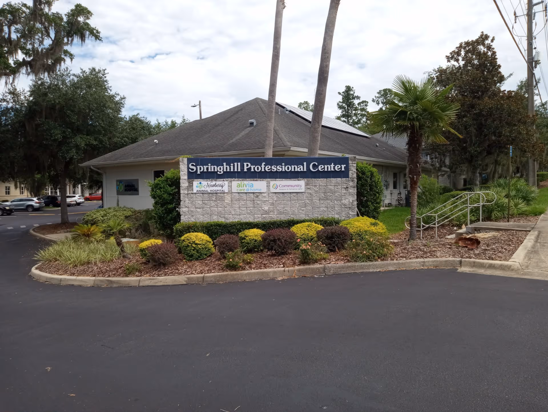 Exterior view of Springhill Professional Center with landscaped front shrubs.