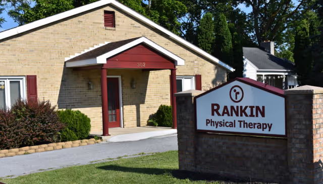 Exterior of Rankin Physical Therapy building with sign and manicured landscaping.