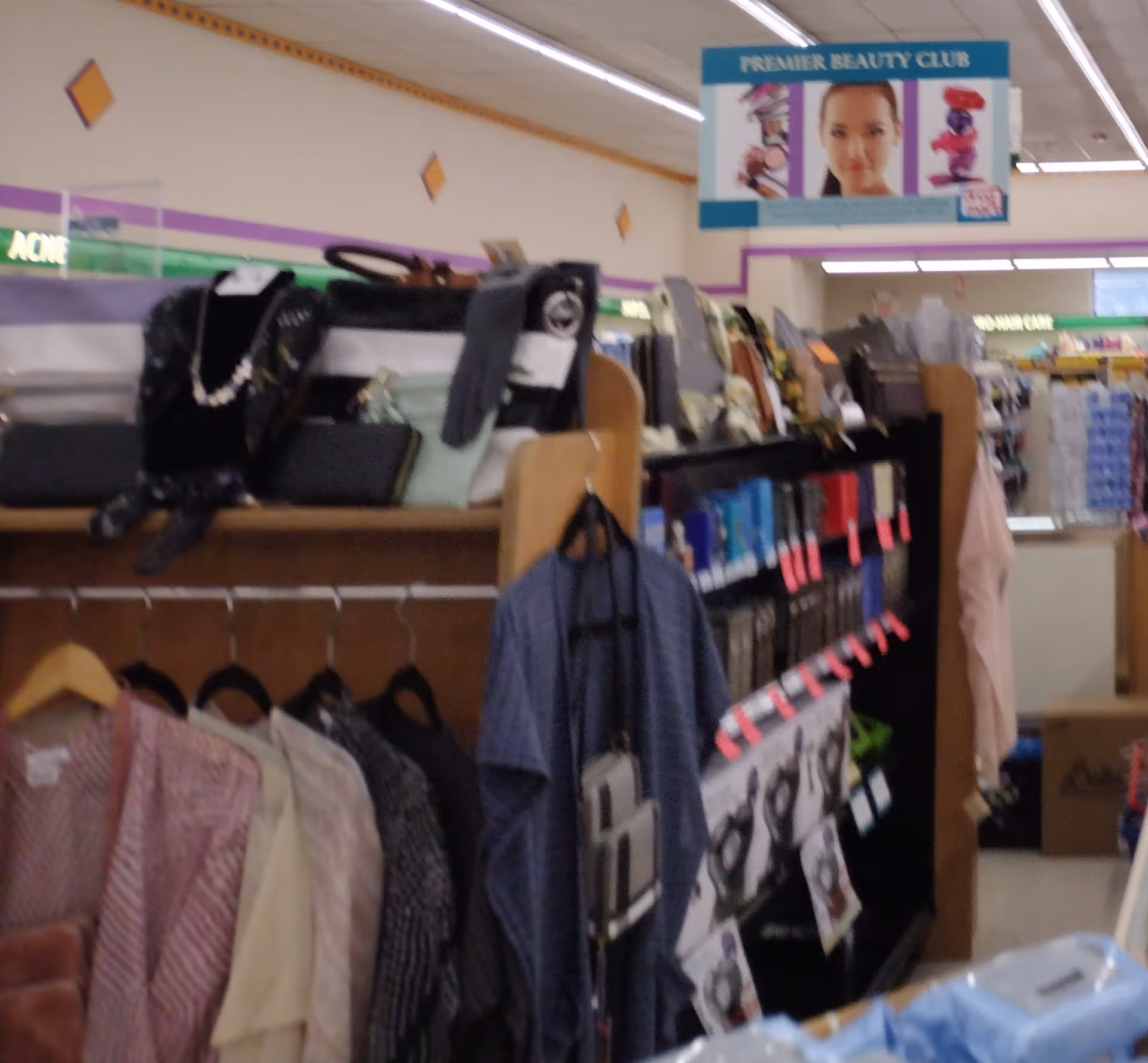 Interior of Discount Drug Mart showing clothing racks and shelves in a store aisle.