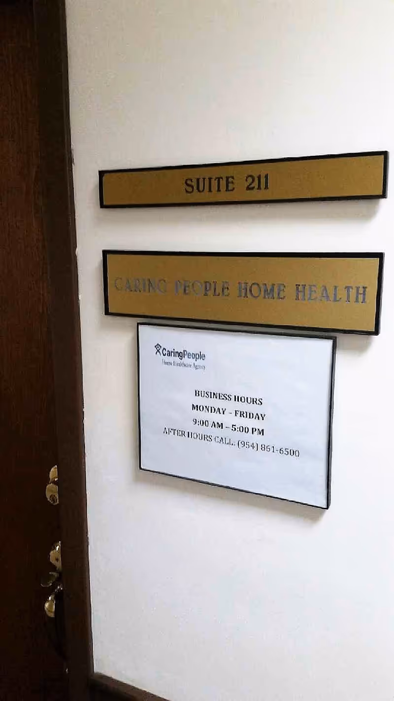 Interior hallway with door sign reading Suite 211 and Caring People Home Health