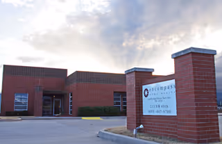 Exterior view of Enhabit Home Health facility with brick facade and entrance sign.