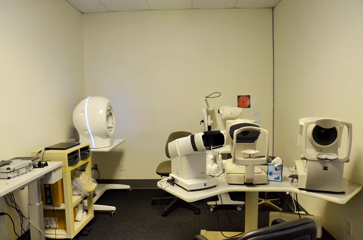 Eye clinic exam room filled with ophthalmic diagnostic equipment.
