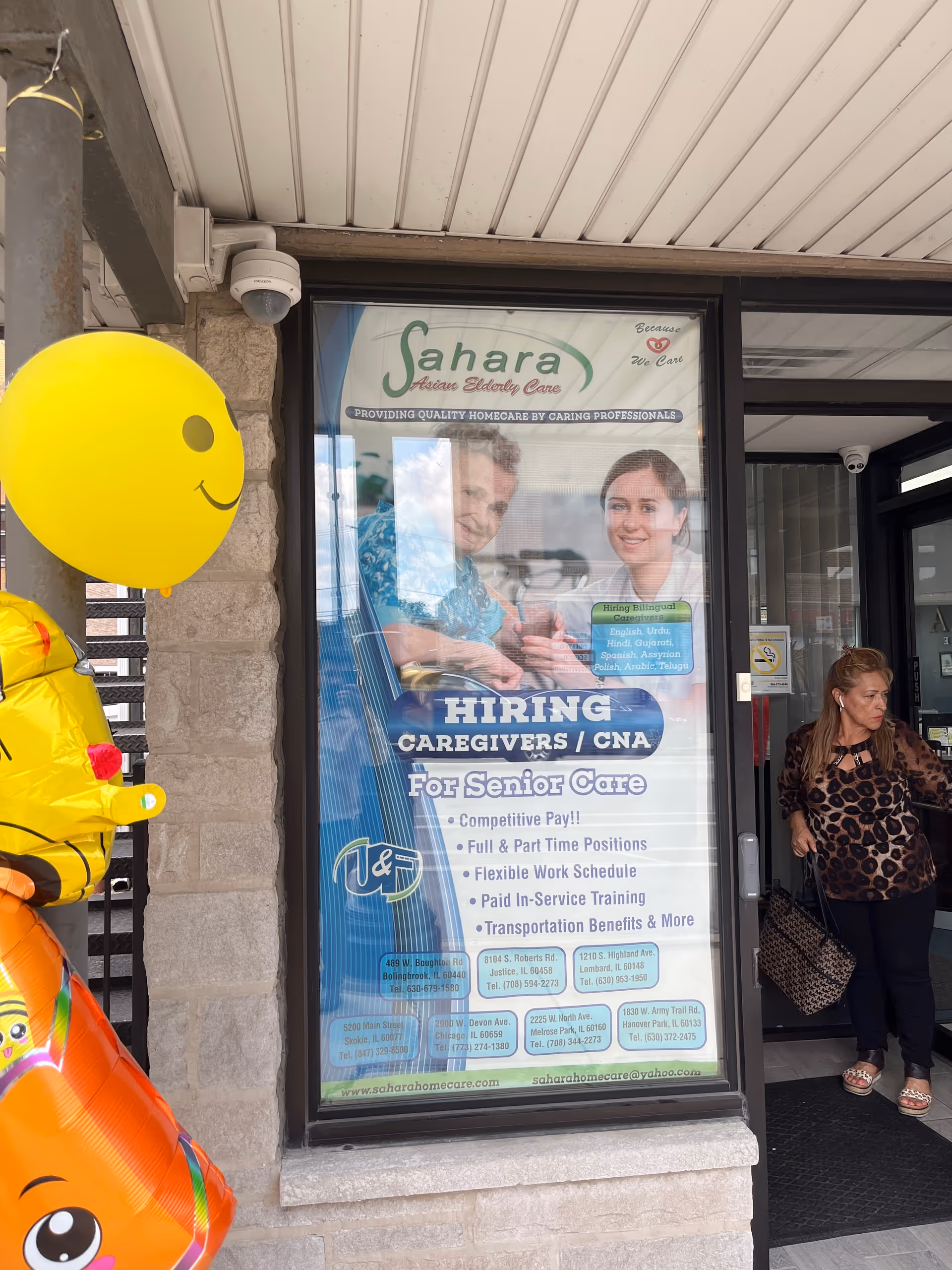 Sahara Home Care storefront with a large hiring poster and a woman entering.