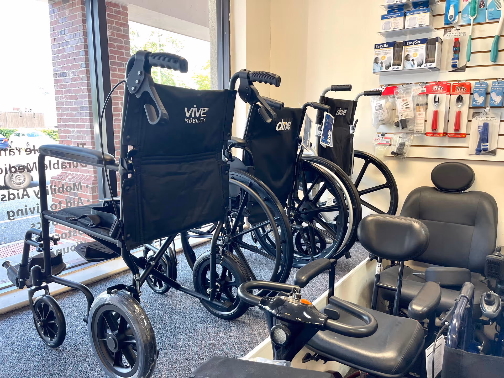 Several mobility wheelchairs and assistive devices displayed inside a showroom.