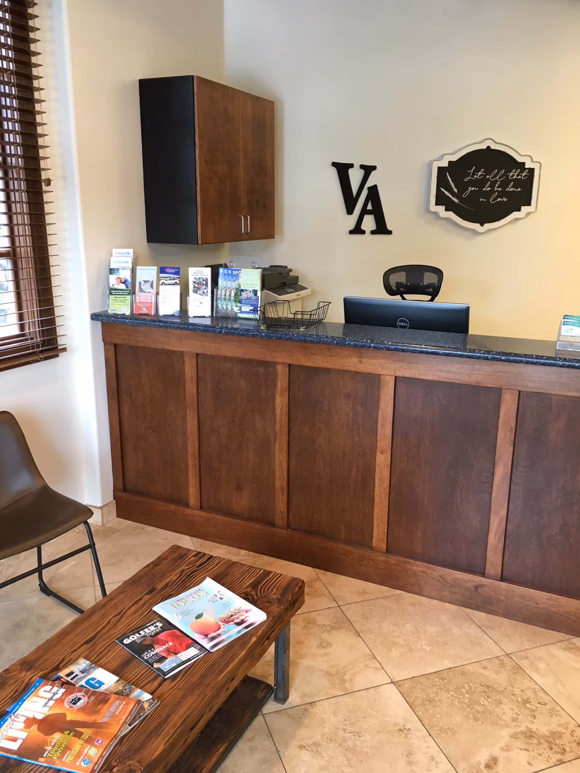 Reception desk in a senior care lobby with brochures and VA letters on the wall.