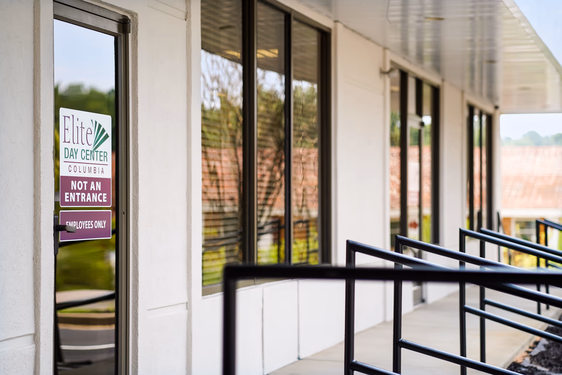 Exterior view of Elite Day Center with windows, railing, and entrance sign