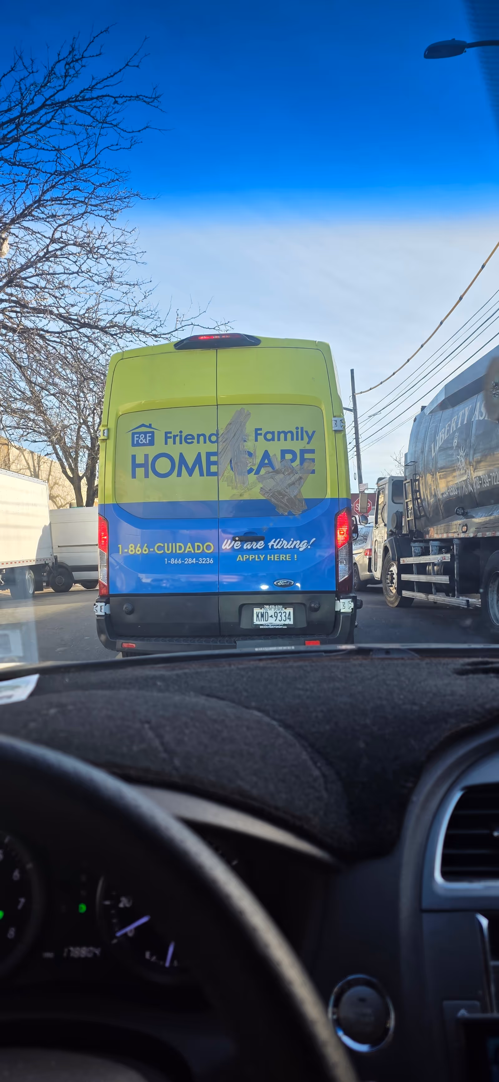 Back of a yellow-green Friends and Family Home Care van in a parking lot.
