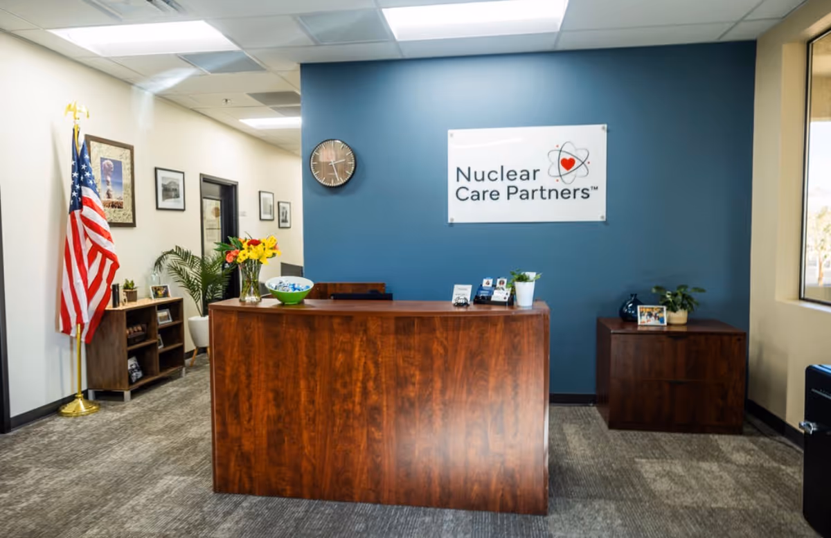 Reception desk in a facility lobby with blue wall and Nuclear Care Partners sign.
