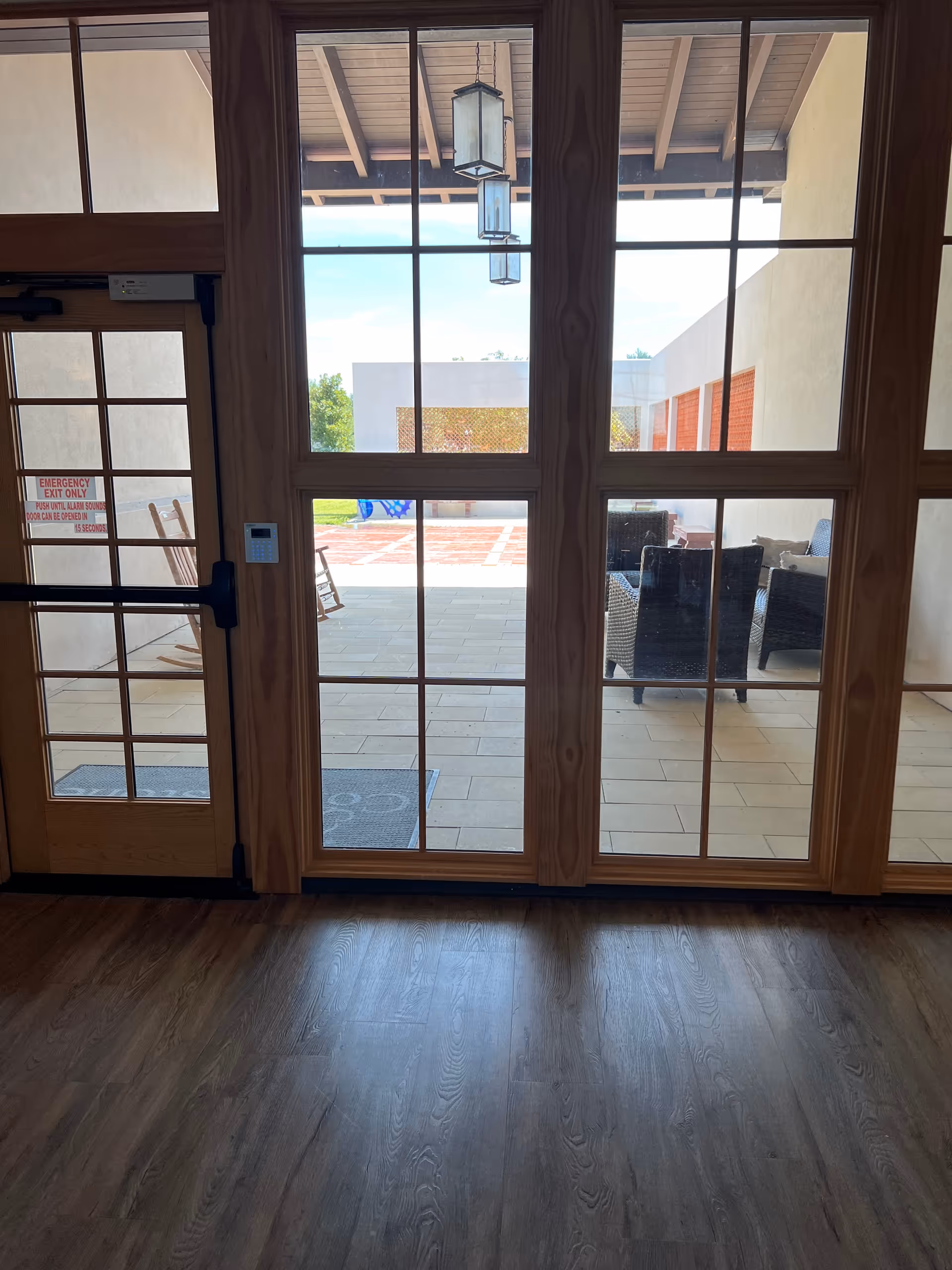 Indoor room with large glass doors opening to an outdoor seating area.