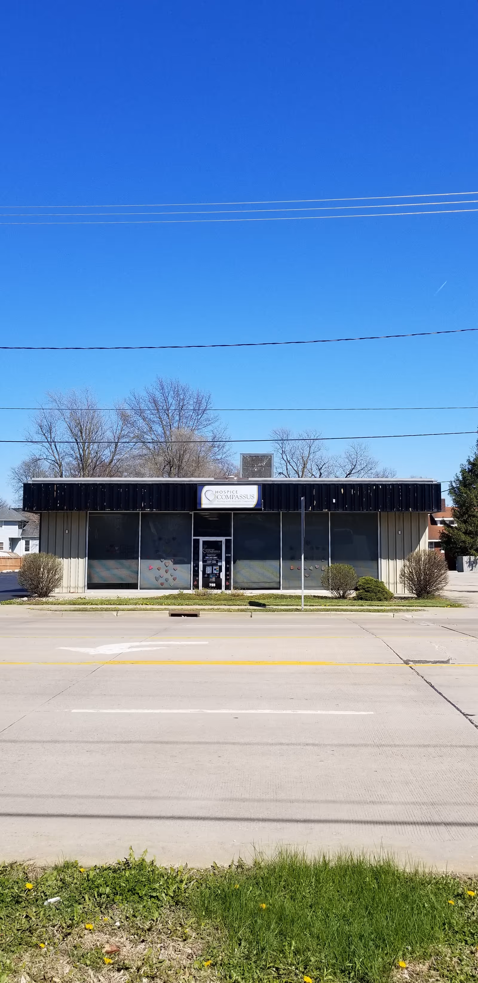 A single-story Compassus facility storefront along a street.