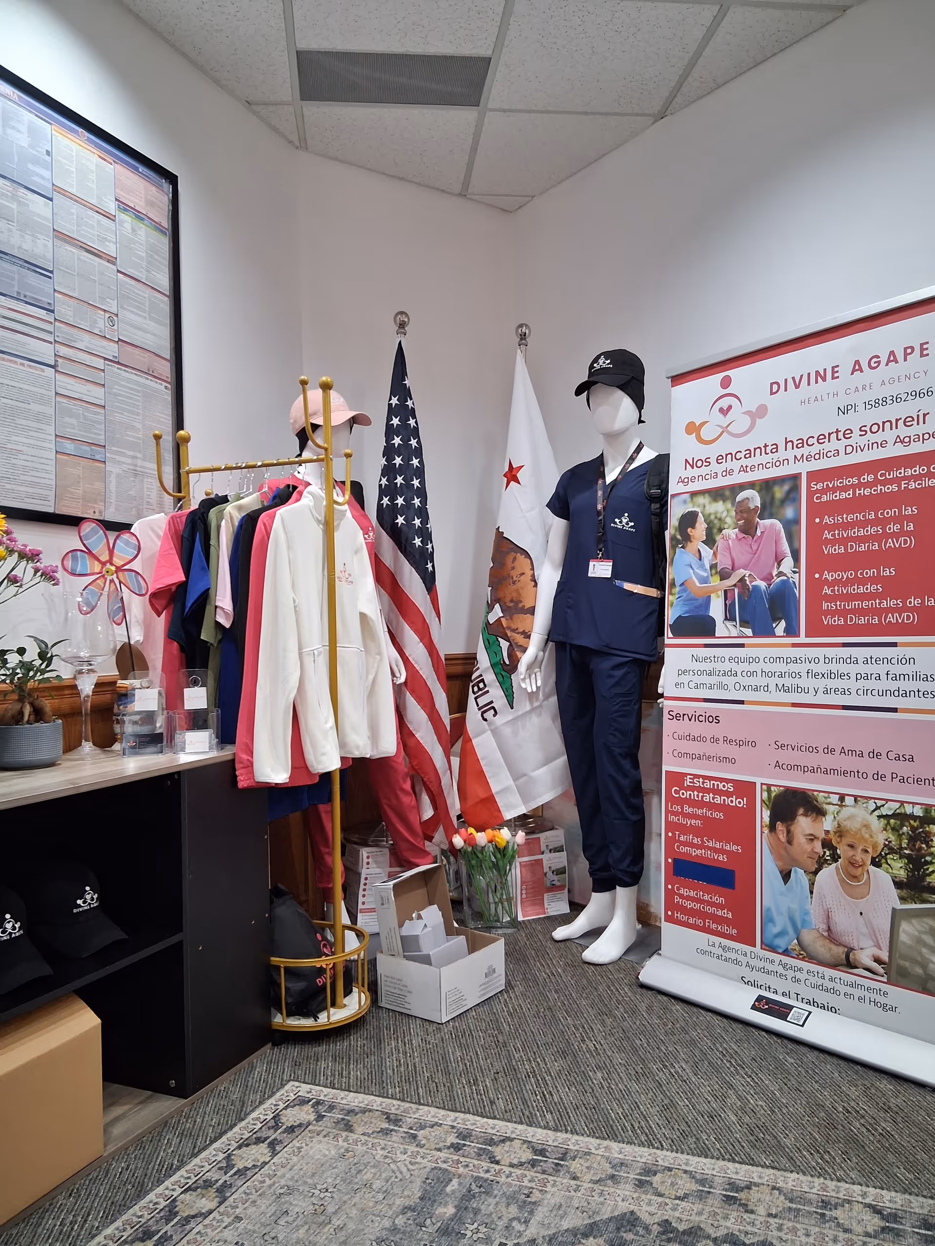 Interior display area with clothing racks, a mannequin in scrubs, and banners.
