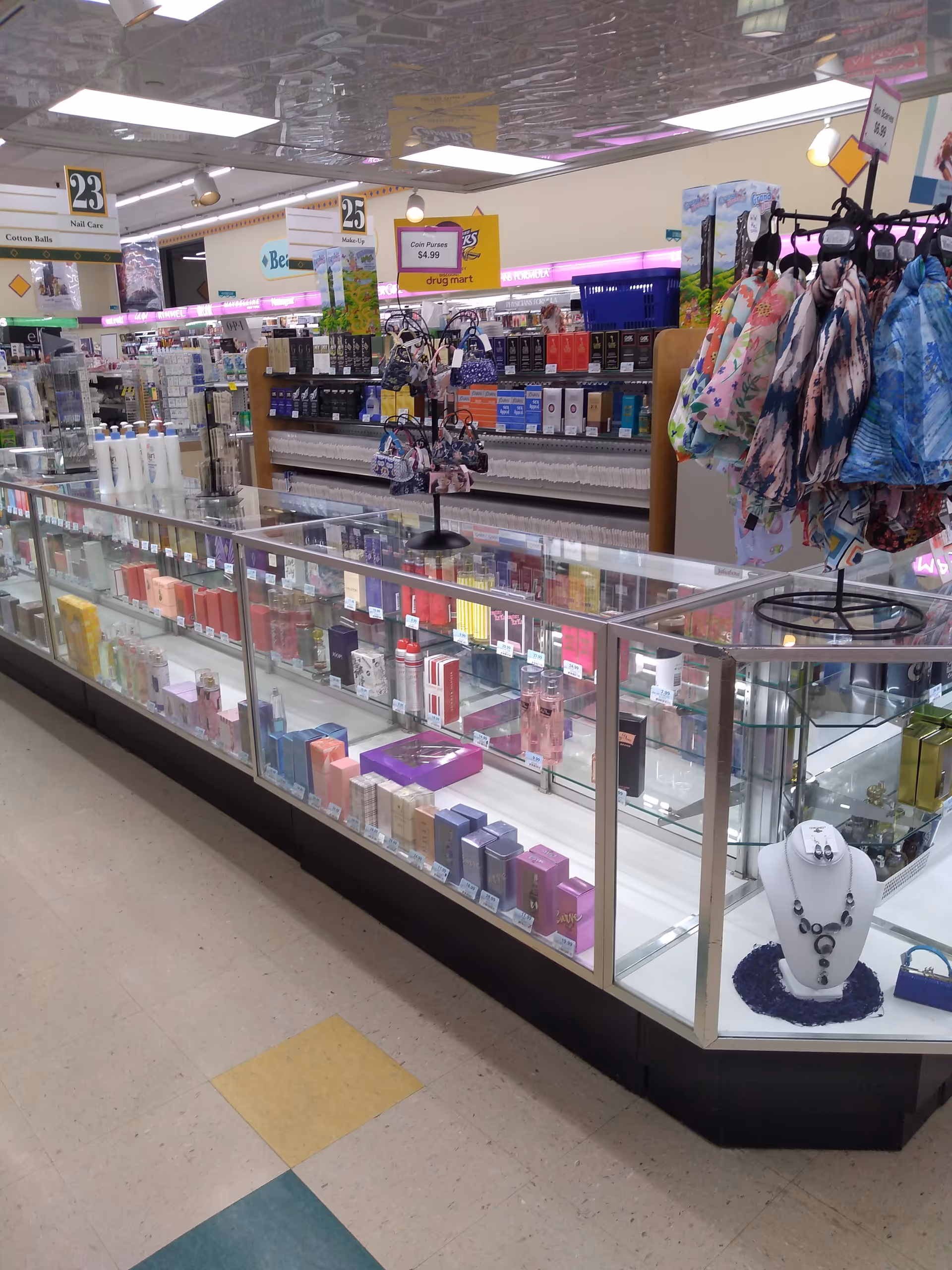 A brightly lit Discount Drug Mart interior featuring glass display cases and jewelry.
