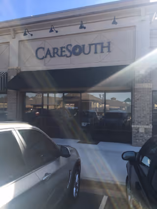 Front exterior of a CareSouth facility with a glass storefront and dark awning.