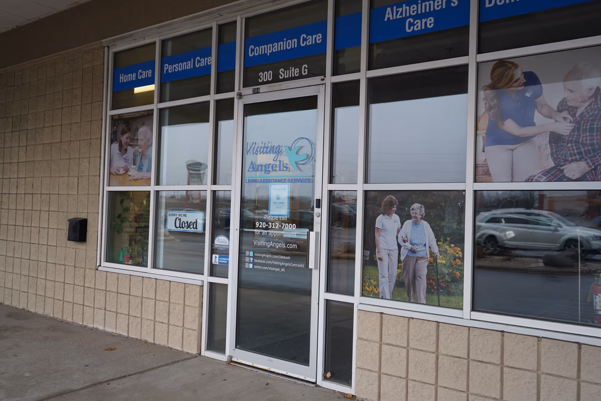 Exterior view of Visiting Angels Oshkosh building with window signs and entrance.