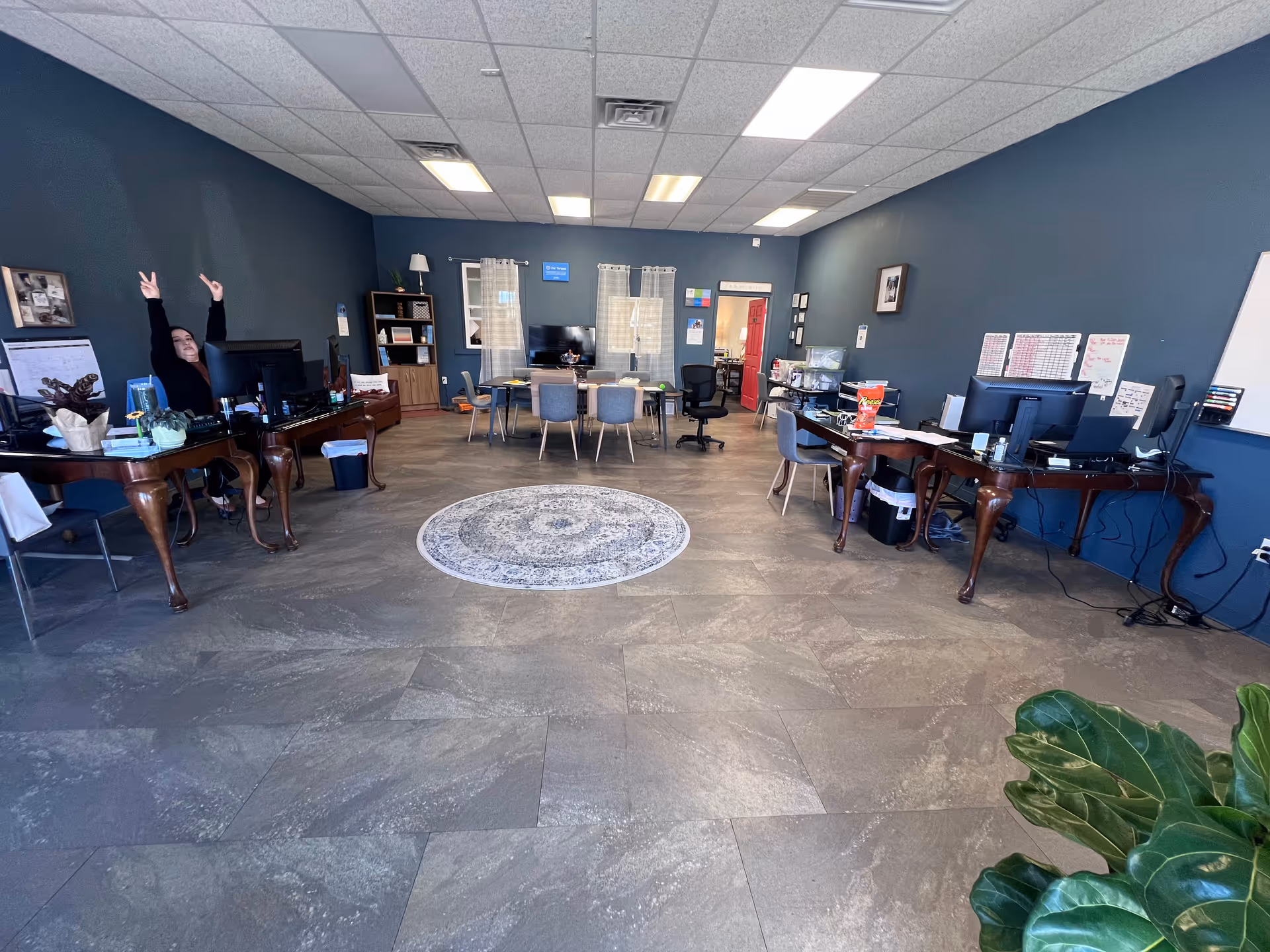 Office-like communal area inside Aveanna Healthcare facility with desks and computers.