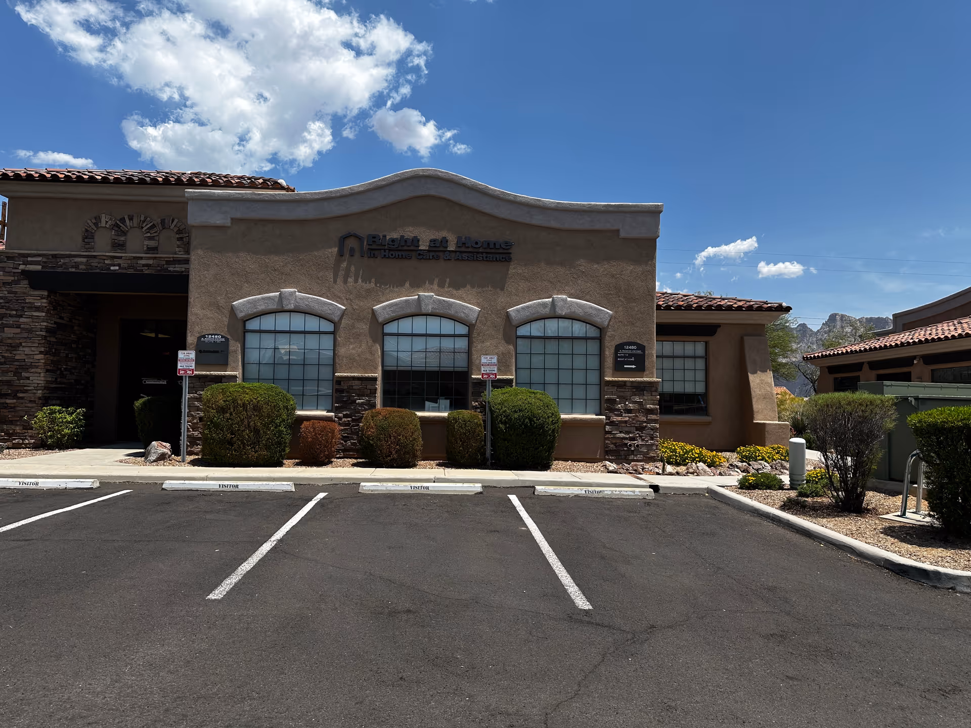 Exterior view of Right at Home senior living building with parking lot.