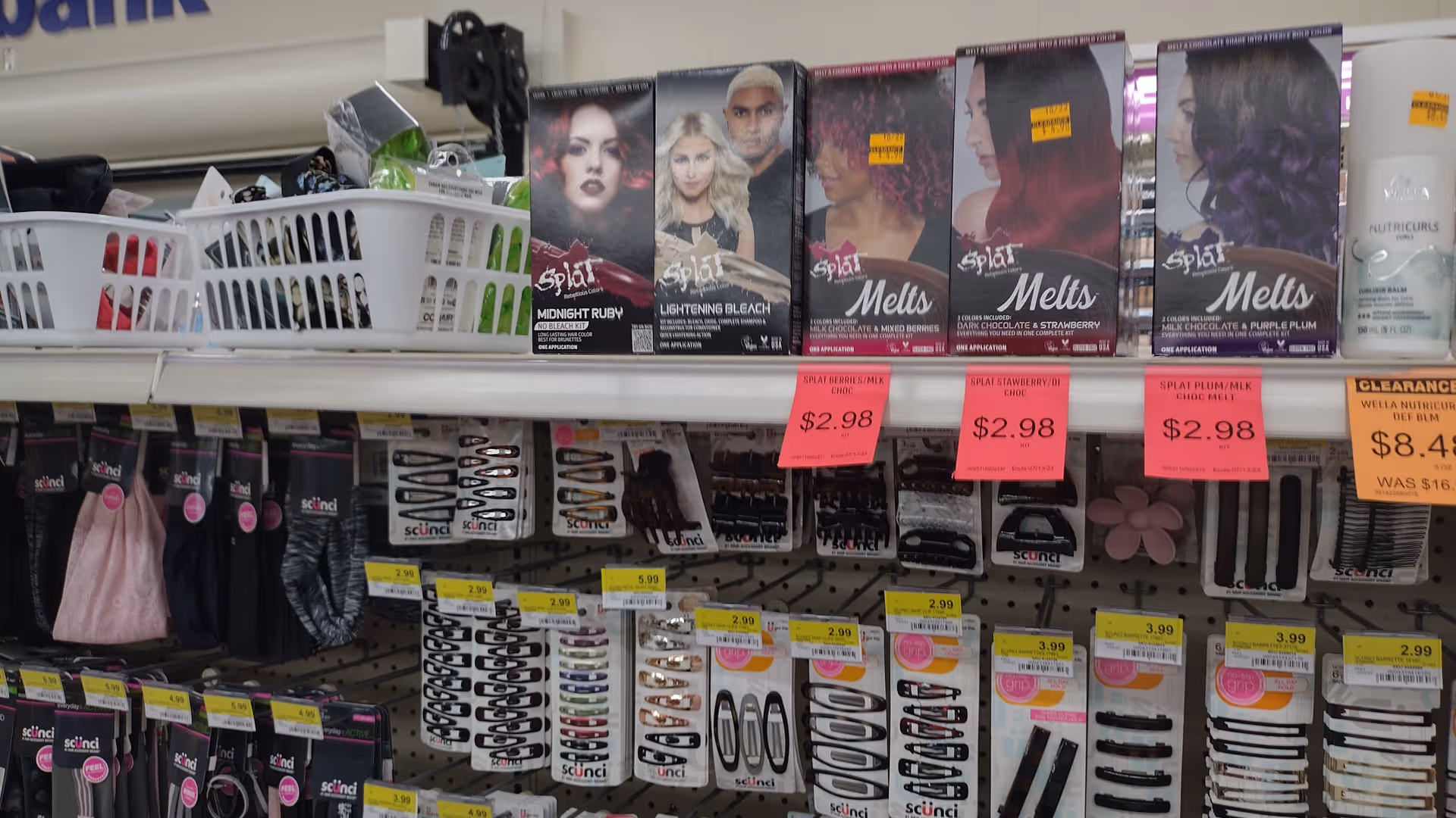 Interior of Discount Drug Mart with shelves of cosmetics and pink sale tags.