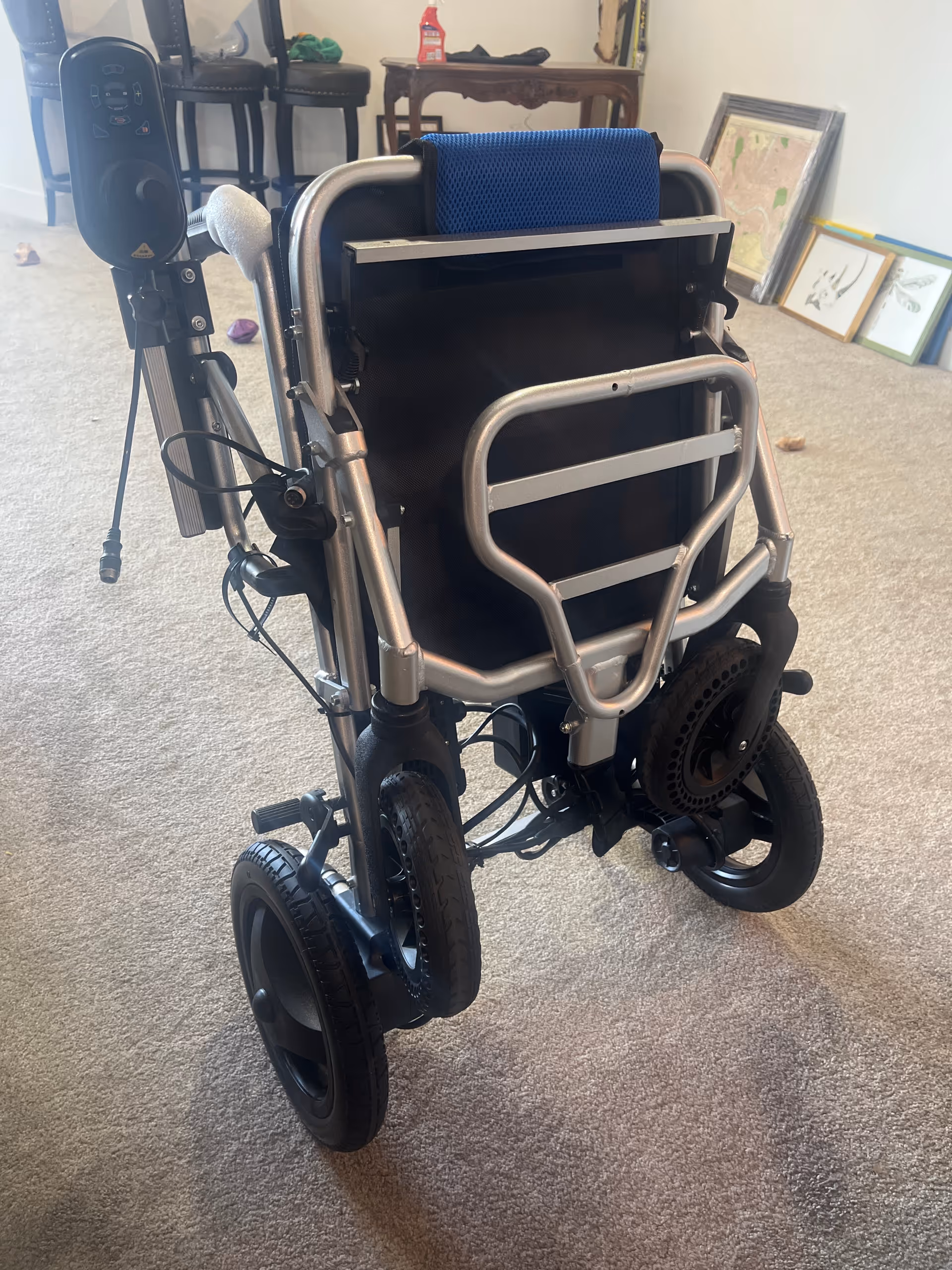 Indoor room with a wheelchair and mobility equipment in a senior living facility.