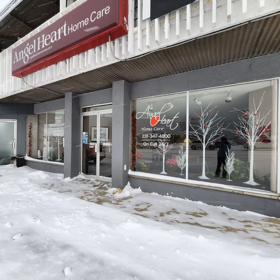 Exterior of Angel Heart Home Care storefront with large sign and winter snow.