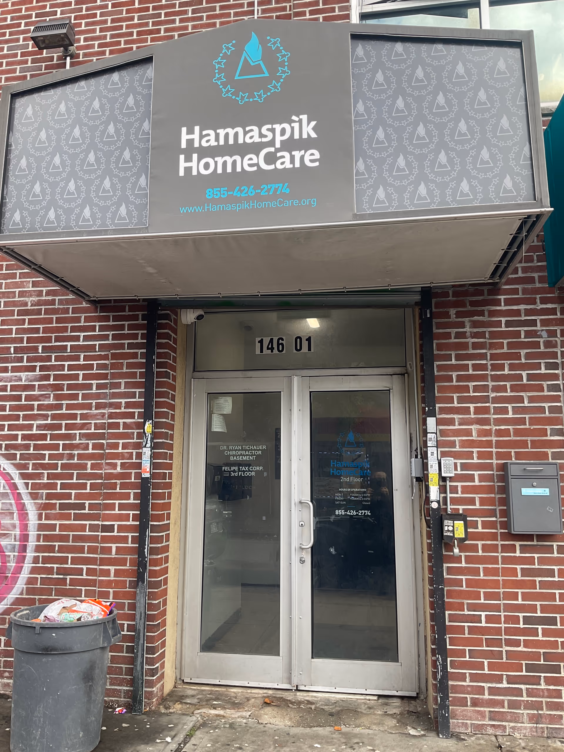 Entrance to Hamaspik HomeCare facility with brick facade and glass doors.