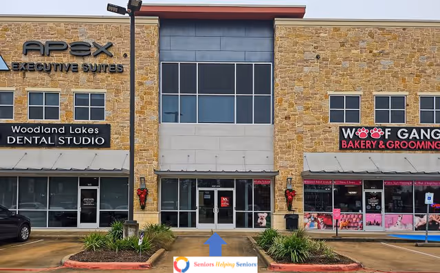 Front view of a strip mall with a Seniors Helping Seniors sign and several storefronts.