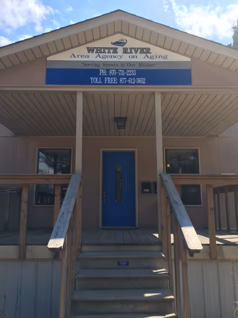 Front view of a building with a blue door and White River Area Agency on Aging.