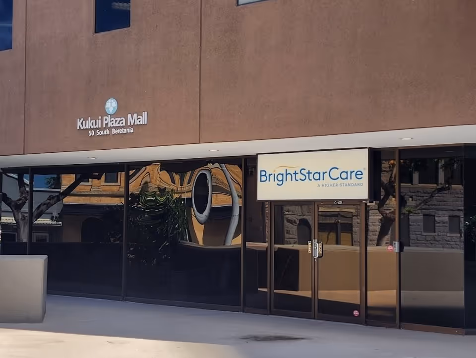Exterior view of BrightStar Care storefront with glass doors on mall façade.