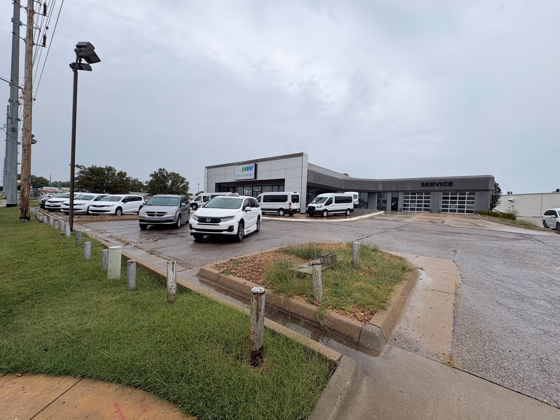 Parking lot in front of MobilityWorks facility with several cars