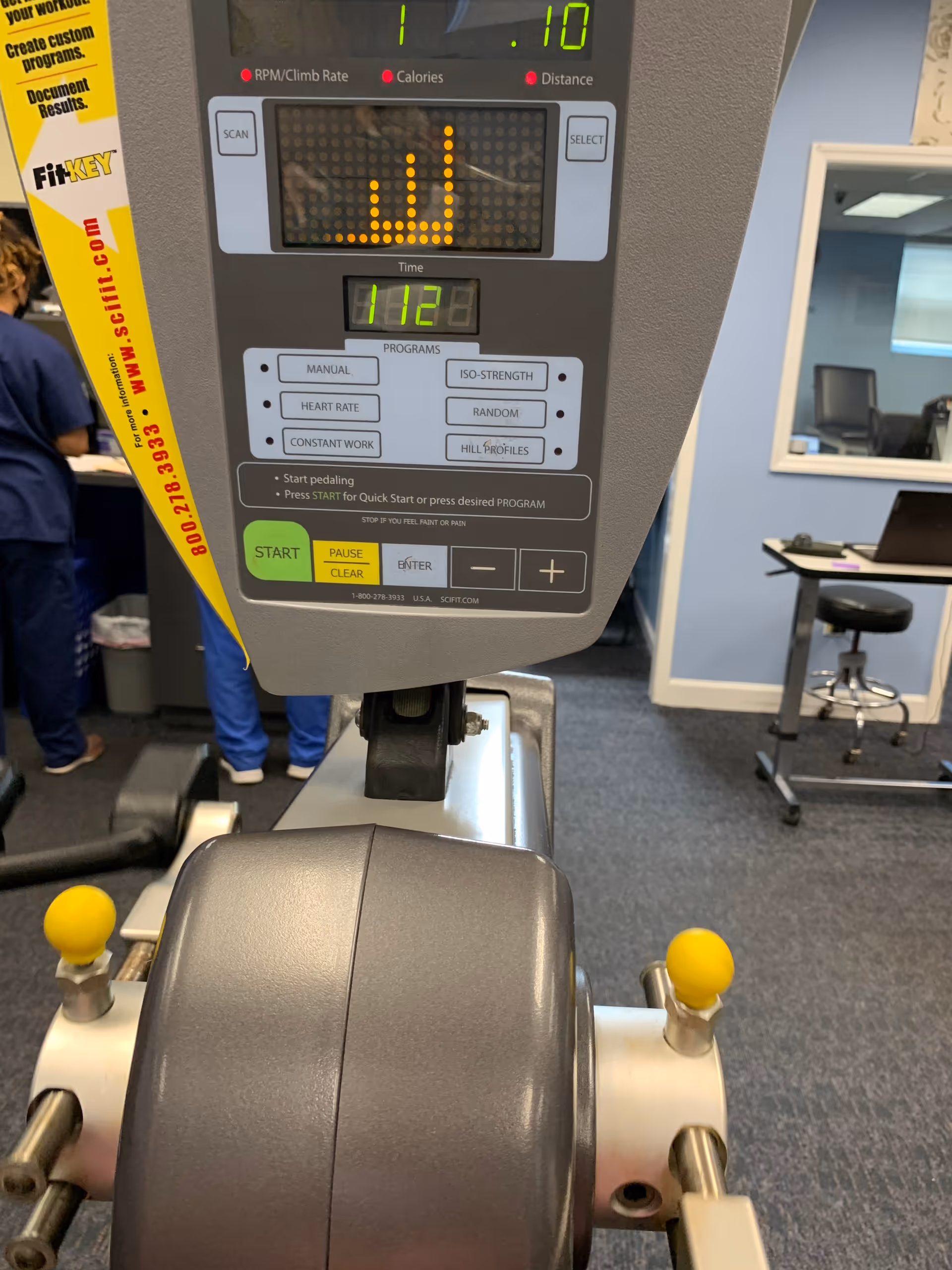 Close-up of a treadmill console in a senior rehab facility gym.