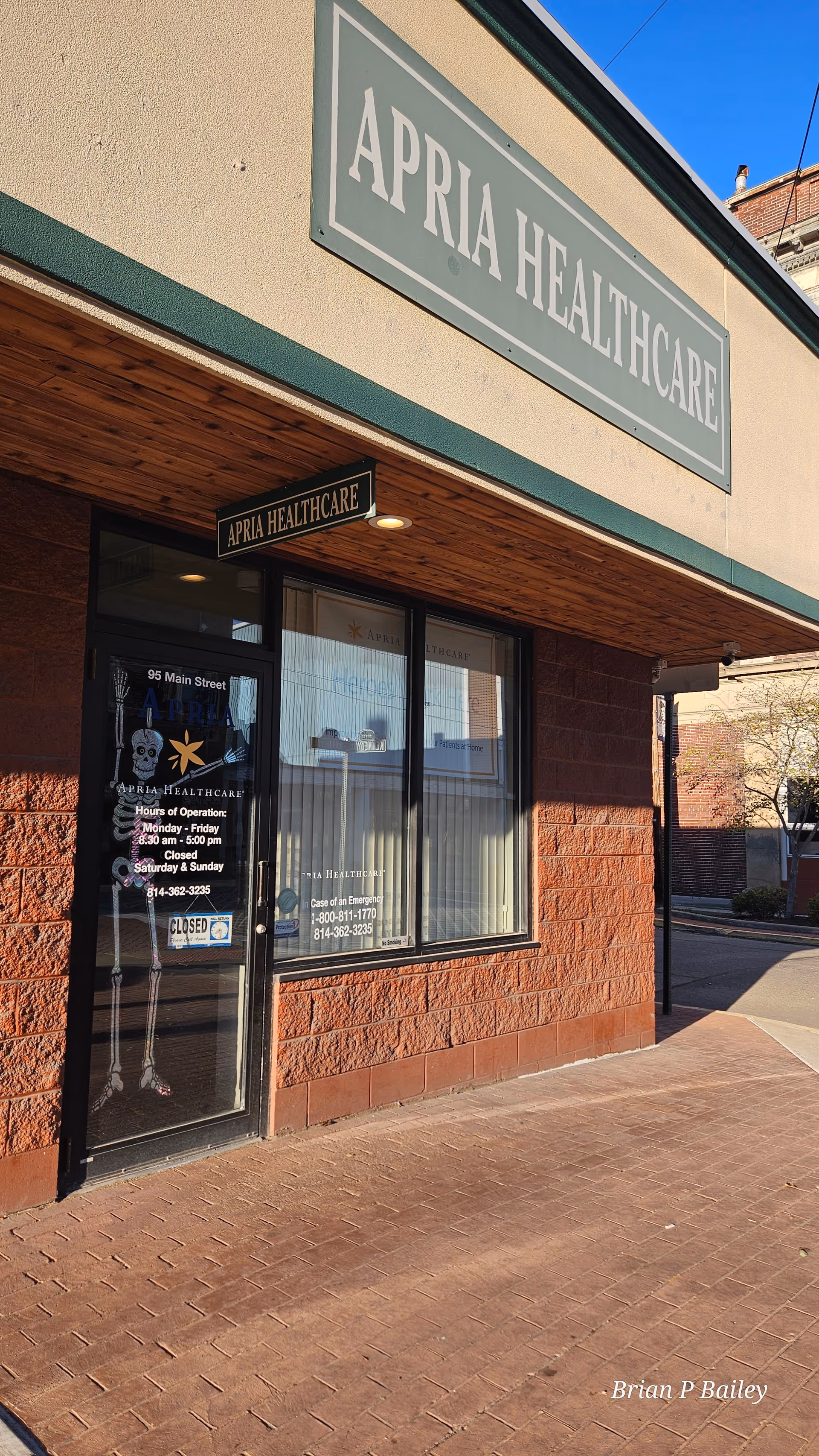Exterior view of Apria Healthcare storefront with large signage.