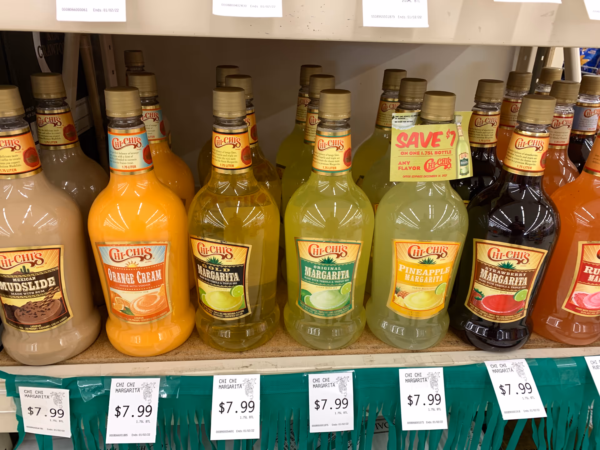 Shelf of Chi-Chi's margarita bottles on a grocery store display.