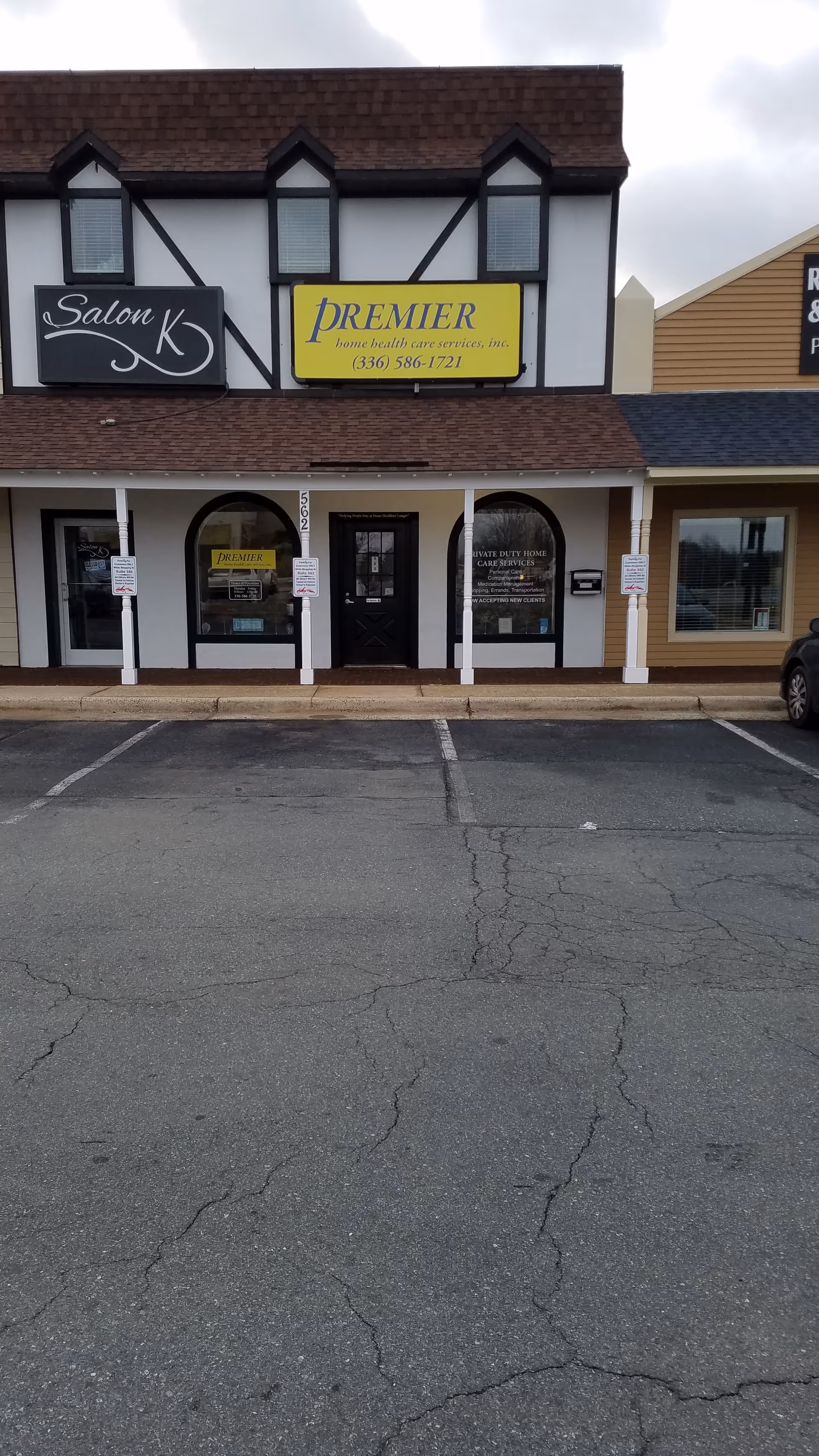 Front view of a strip mall storefront displaying Premier Home Health Care Services signage.