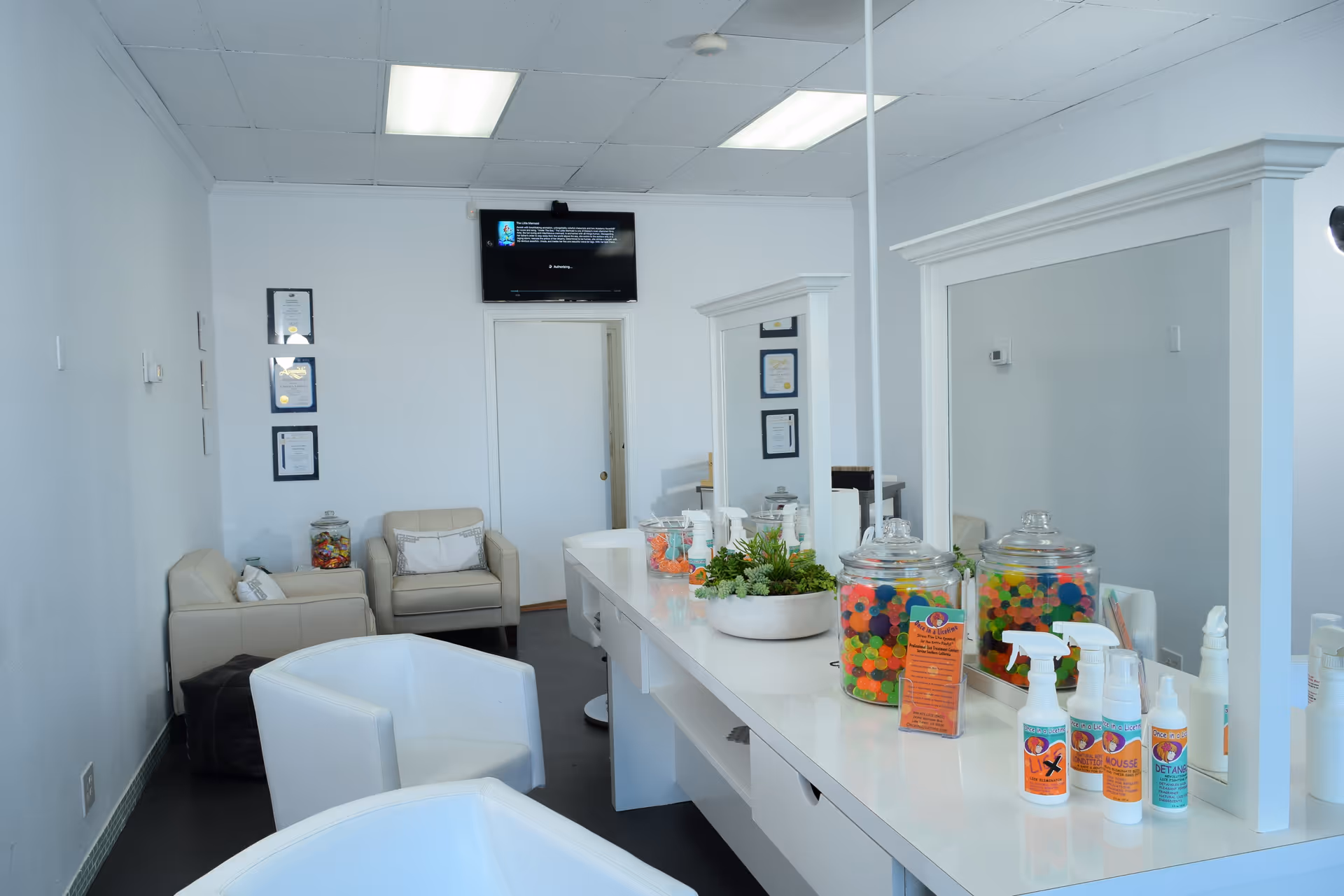 Bright modern facility lobby with a long white counter and candy jars