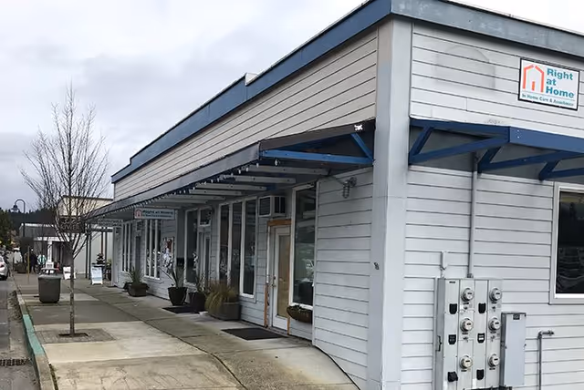 Exterior view of a Right at Home facility storefront with sidewalk and entrance.
