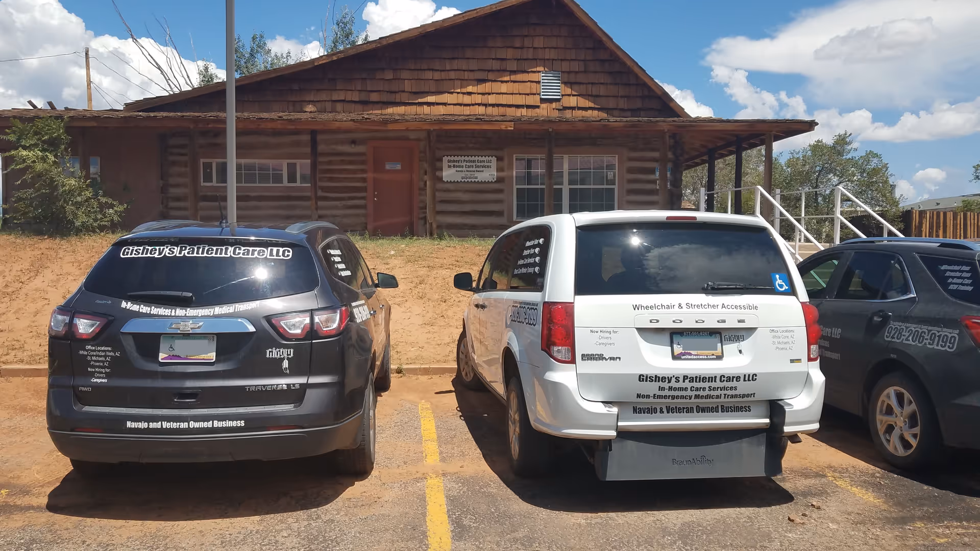 Log cabin-style building with parked Gishey's Patient Care LLC vans.