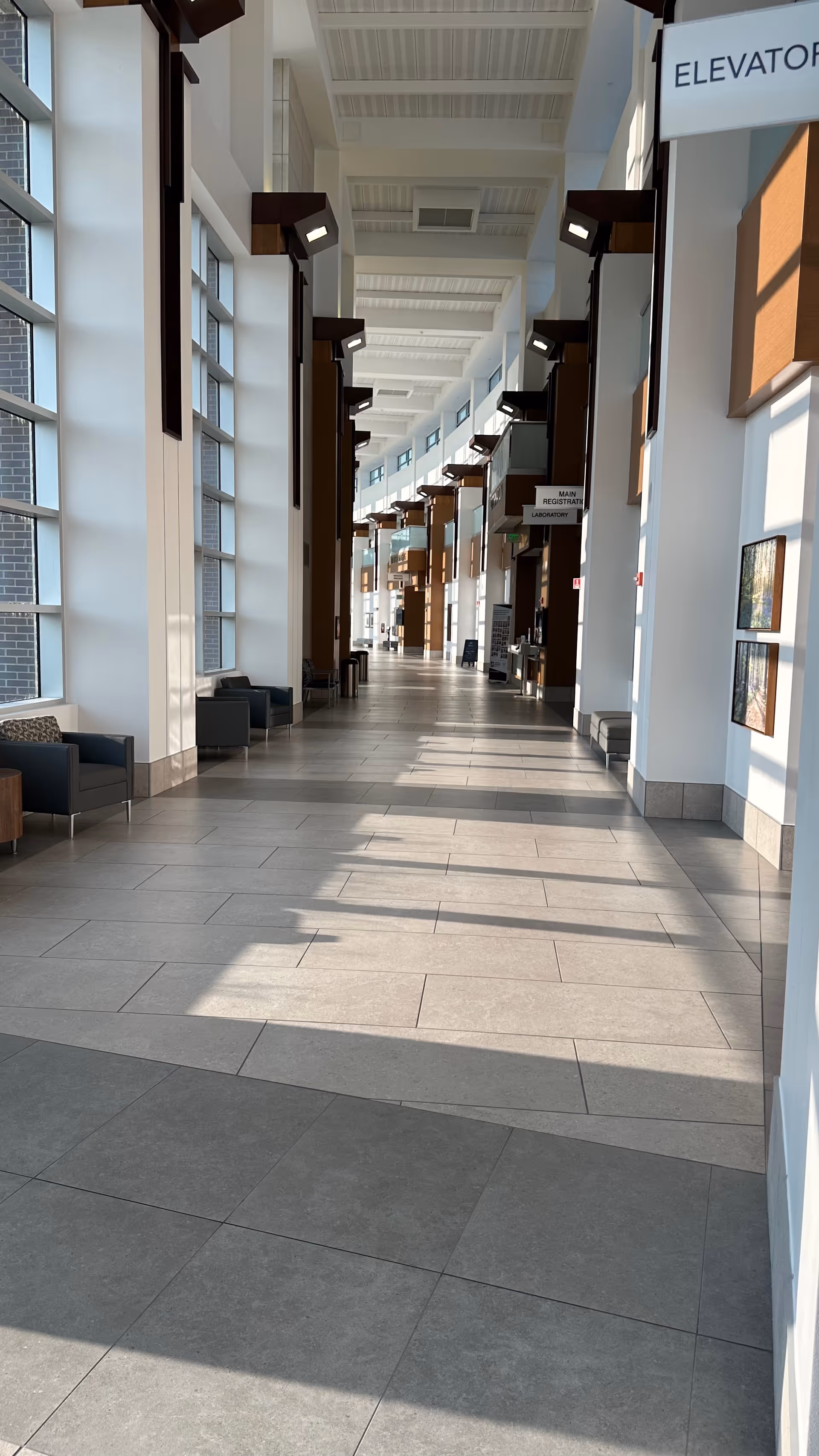 Johnson Memorial Health corridor: long, bright hallway with seating and large windows.