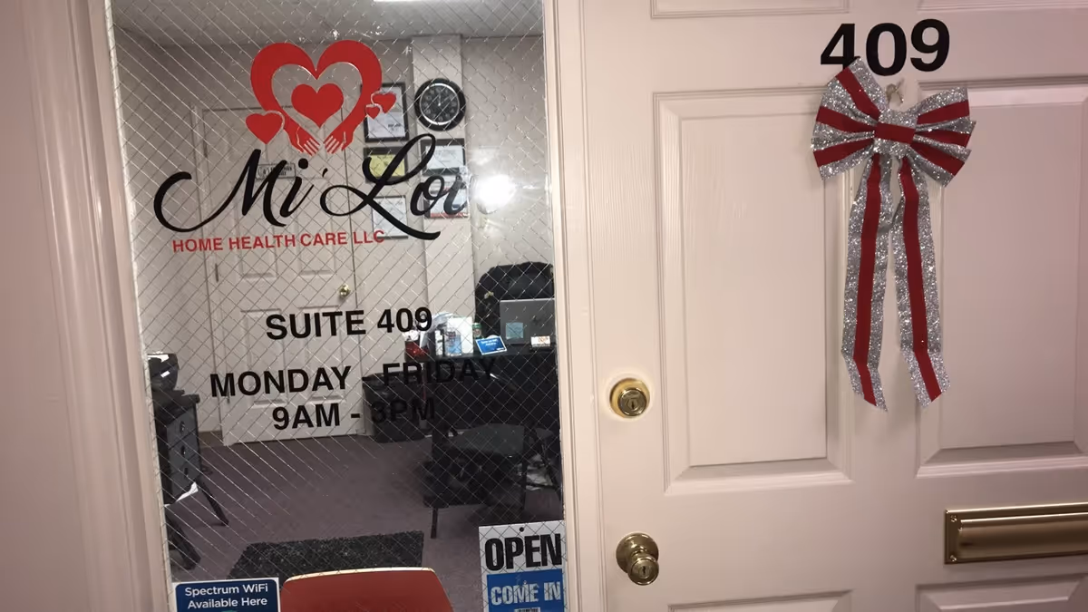 Office entrance showing Mi' Love Home Health Care LLC logo on glass, Suite 409, open sign.