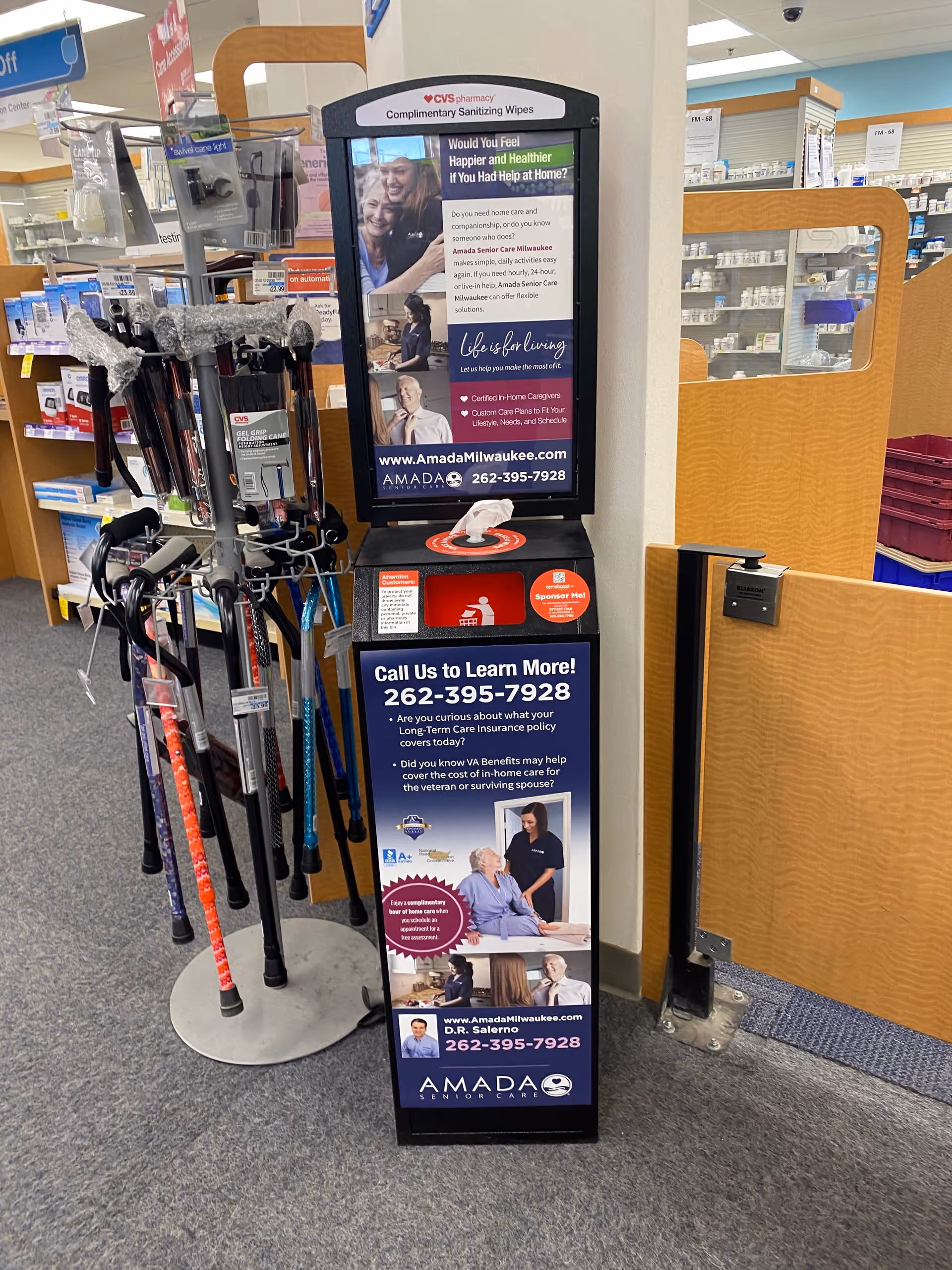 Promotional Amada Senior Care display with brochures beside walking canes in CVS