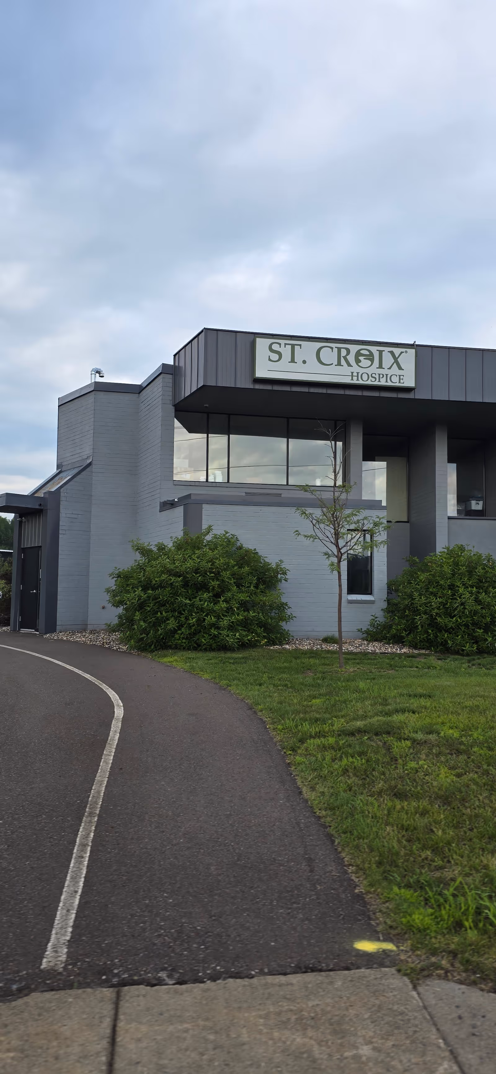 Front exterior of a modern hospice building with a St. Croix Hospice sign.