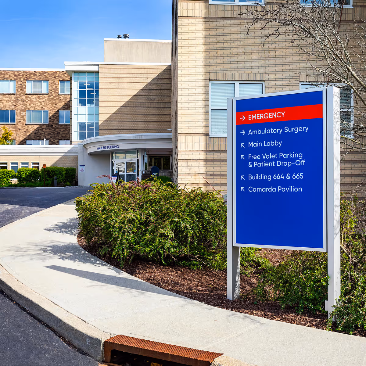 Exterior view of Nuvance Health The Heart Center with a blue directional sign by the entrance.