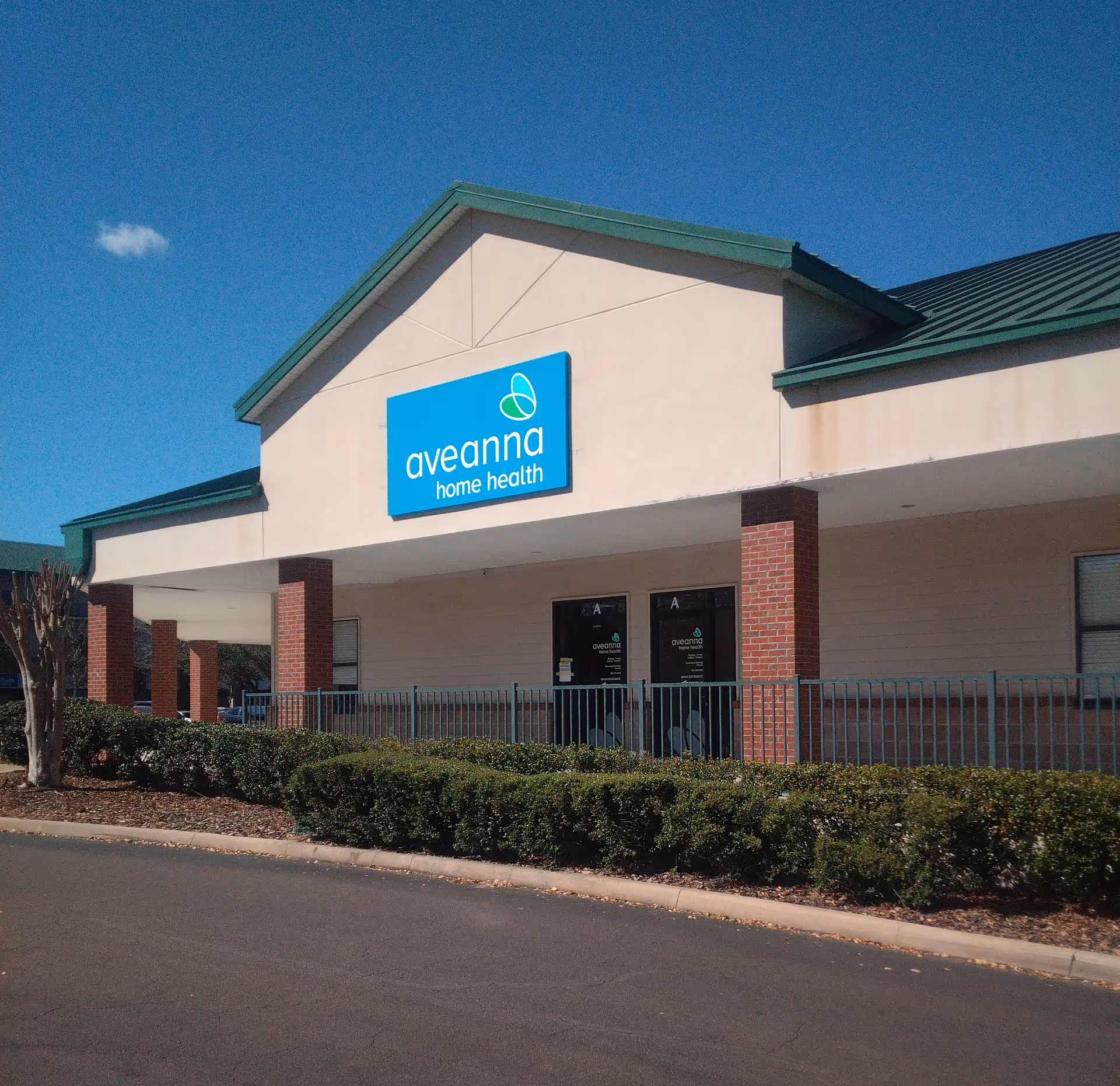 Exterior view of Aveanna Home Health building with blue sign and entrance.