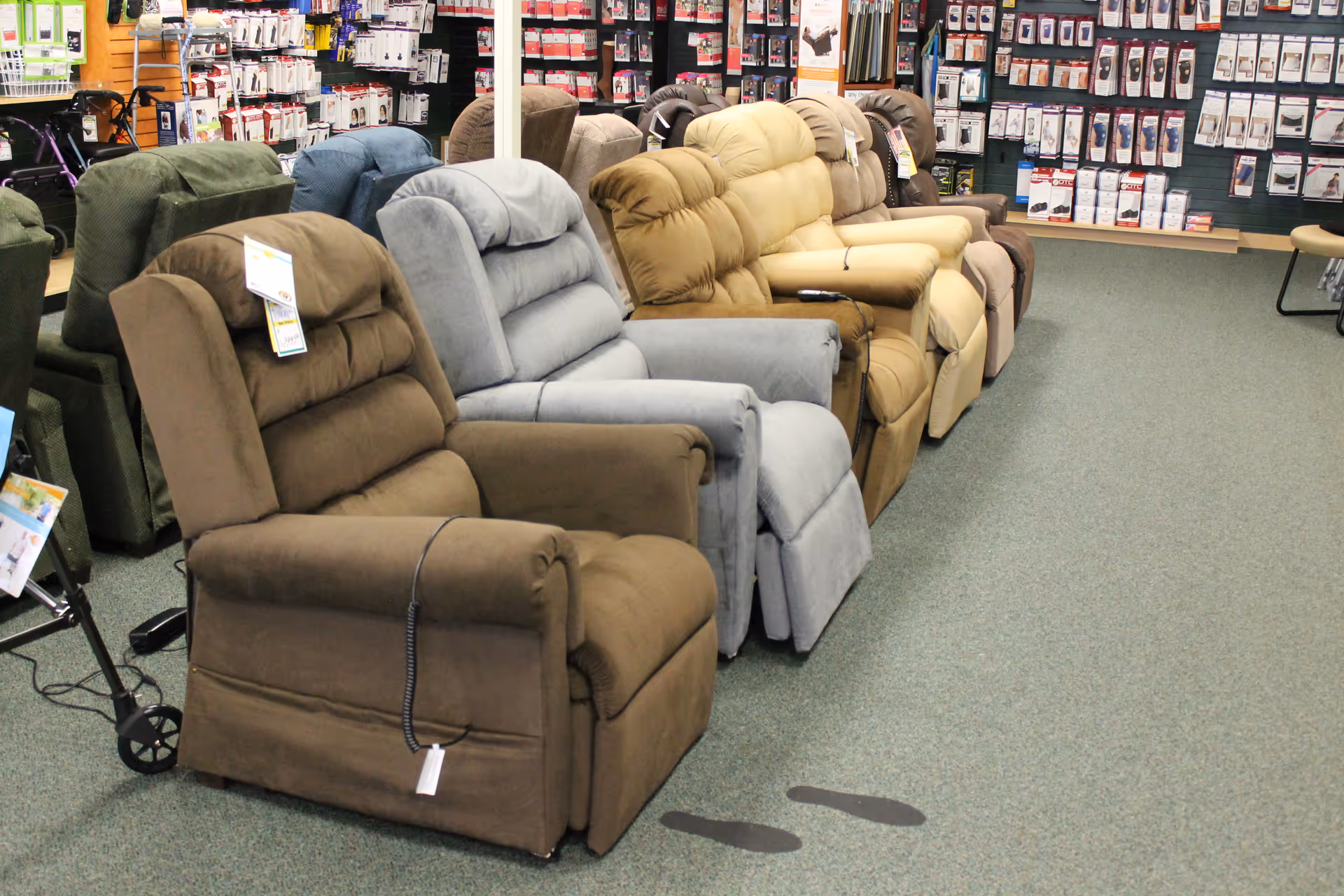 Row of recliner chairs in a showroom with various colors and shopping tags.