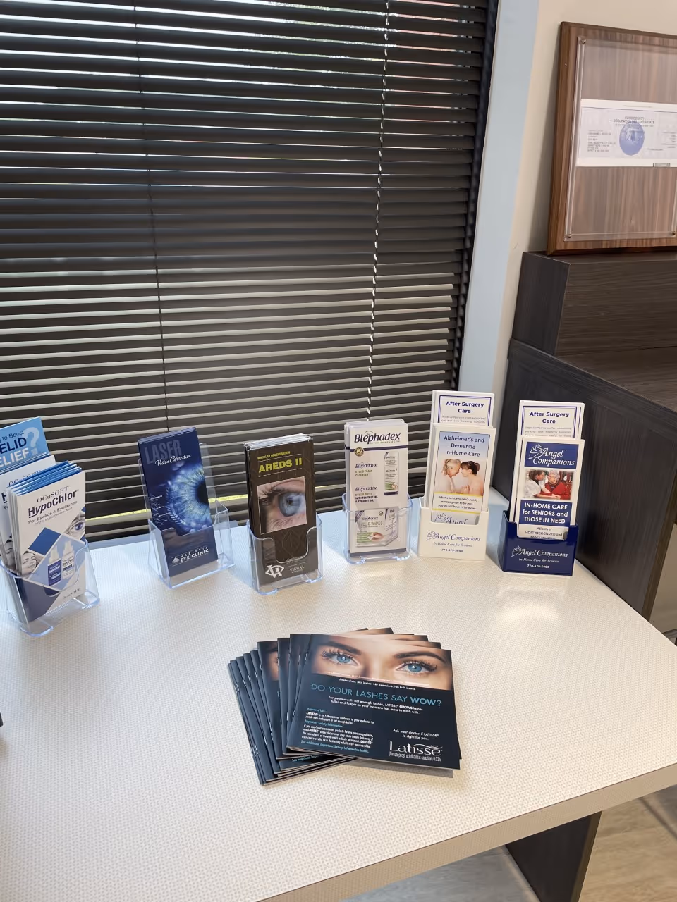 Interior desk area with various pamphlets and brochures on a white table.