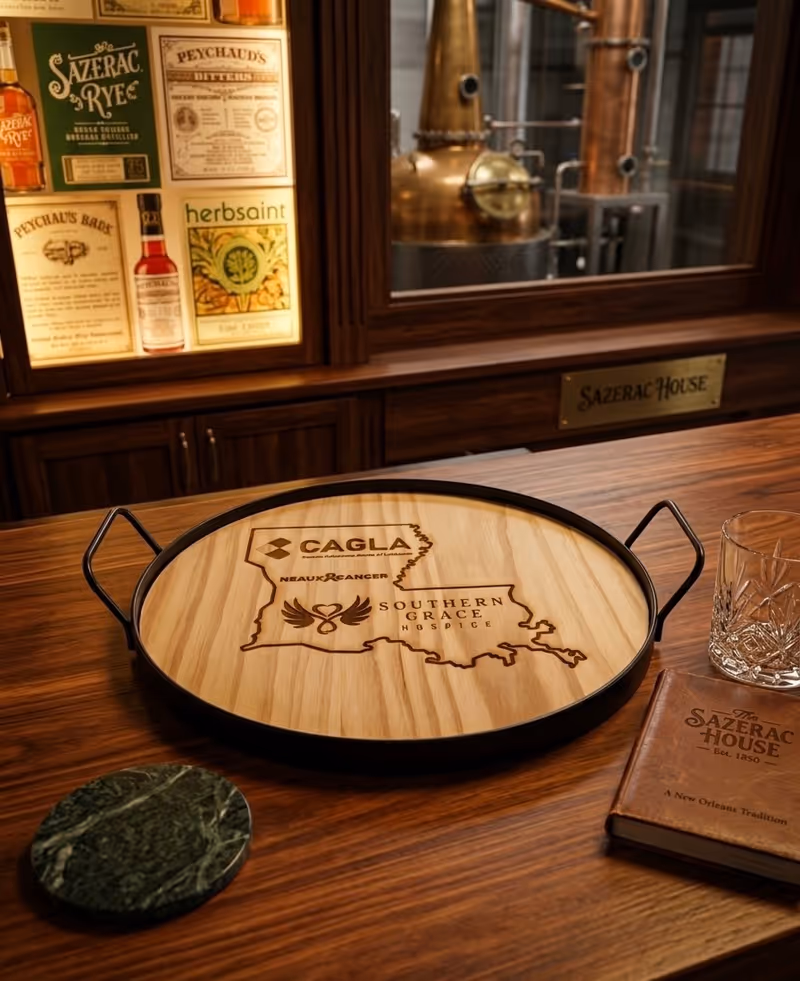 Interior bar area with wooden round tray branded Southern Grace Hospice on a counter.