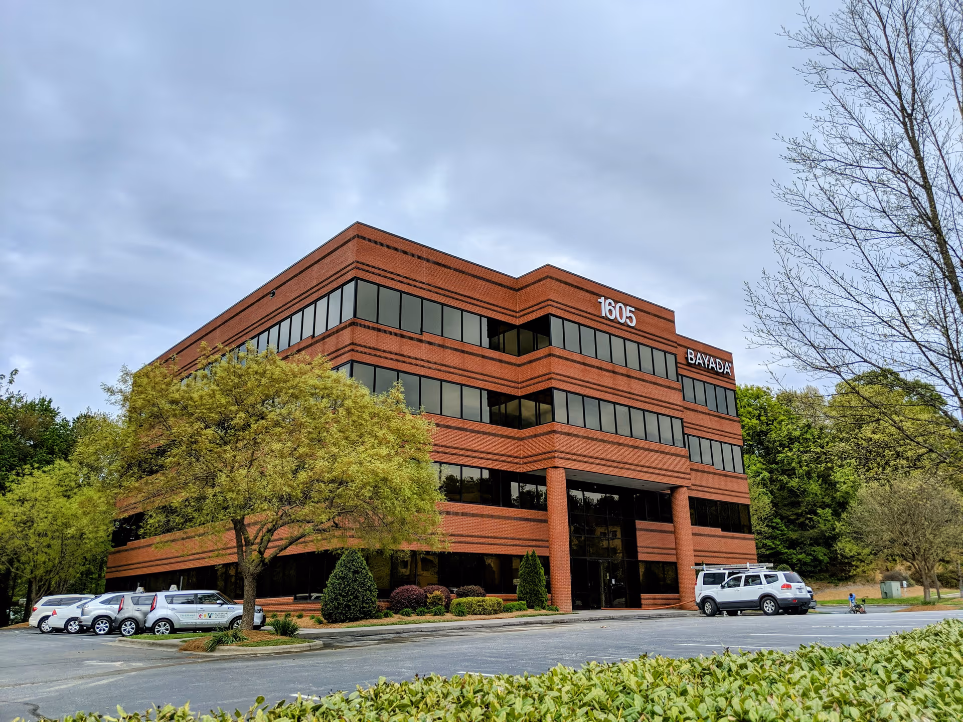 Exterior view of a brick BAYADA Home Health building with a parking lot.