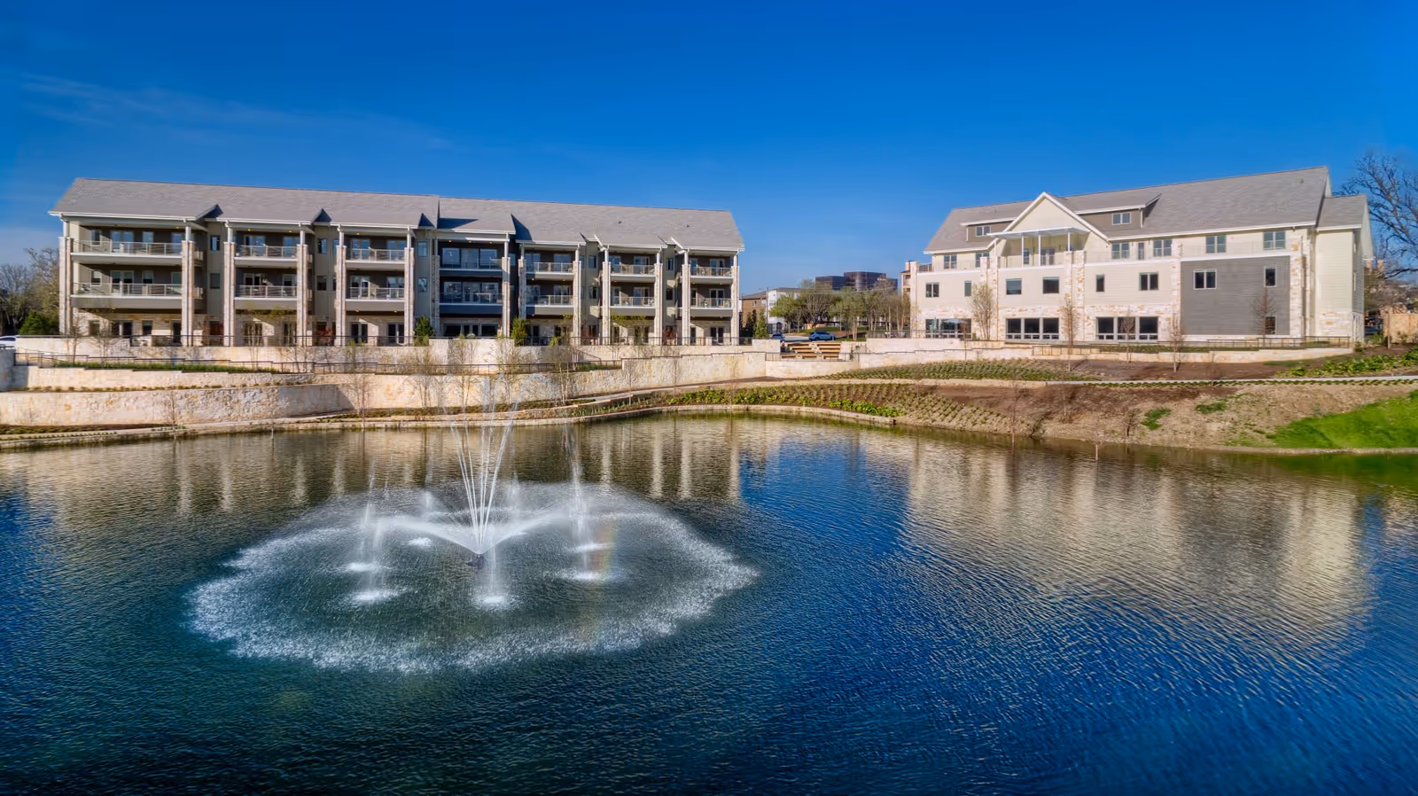 Exterior view of Faith Presbyterian Hospice campus with a pond and fountain.