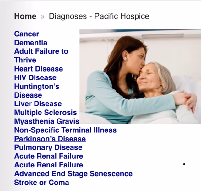 Caregiver tenderly comforts an elderly patient in a medical setting.