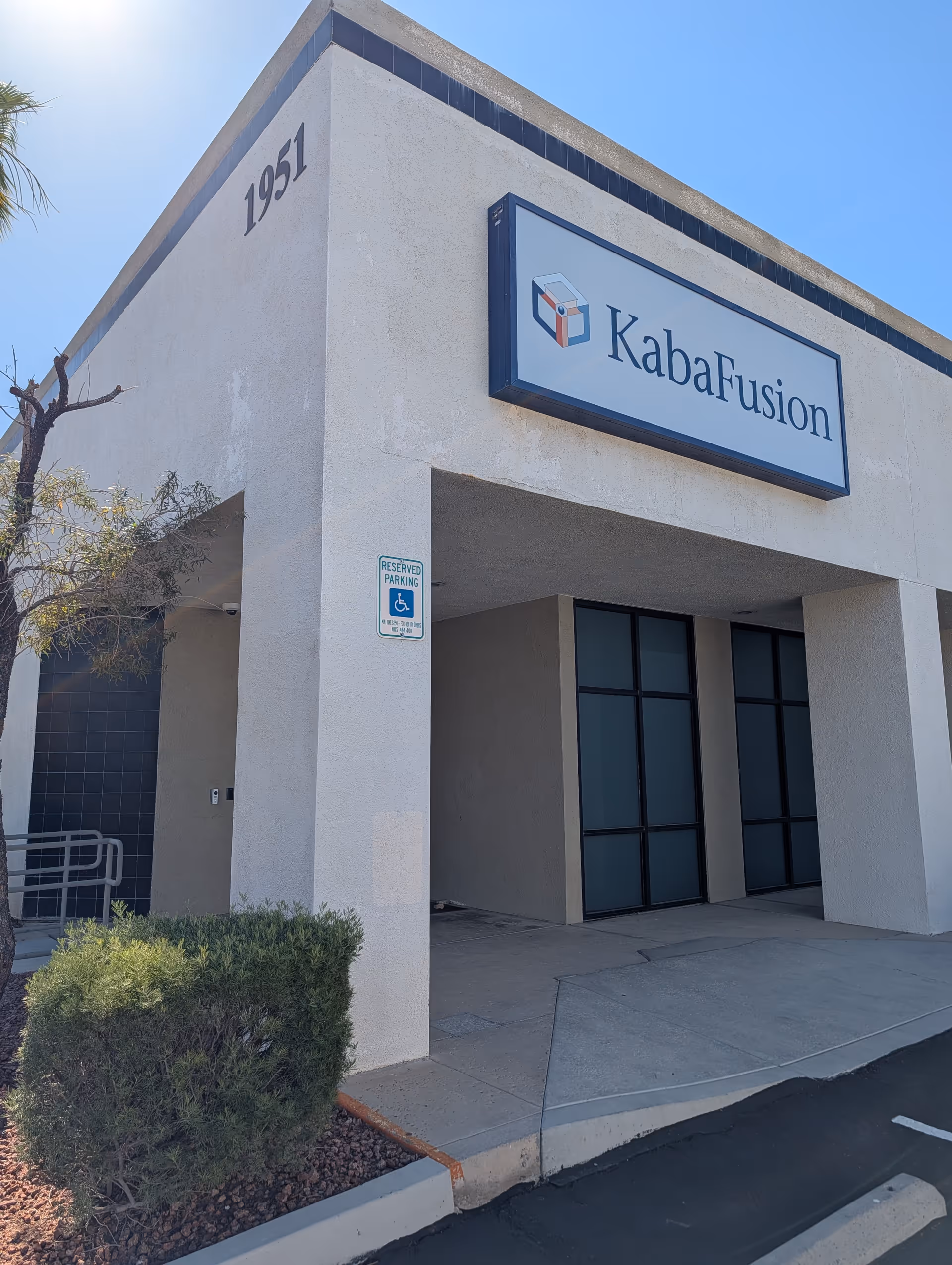 Exterior view of the KabaFusion building with a large sign and entry doors.