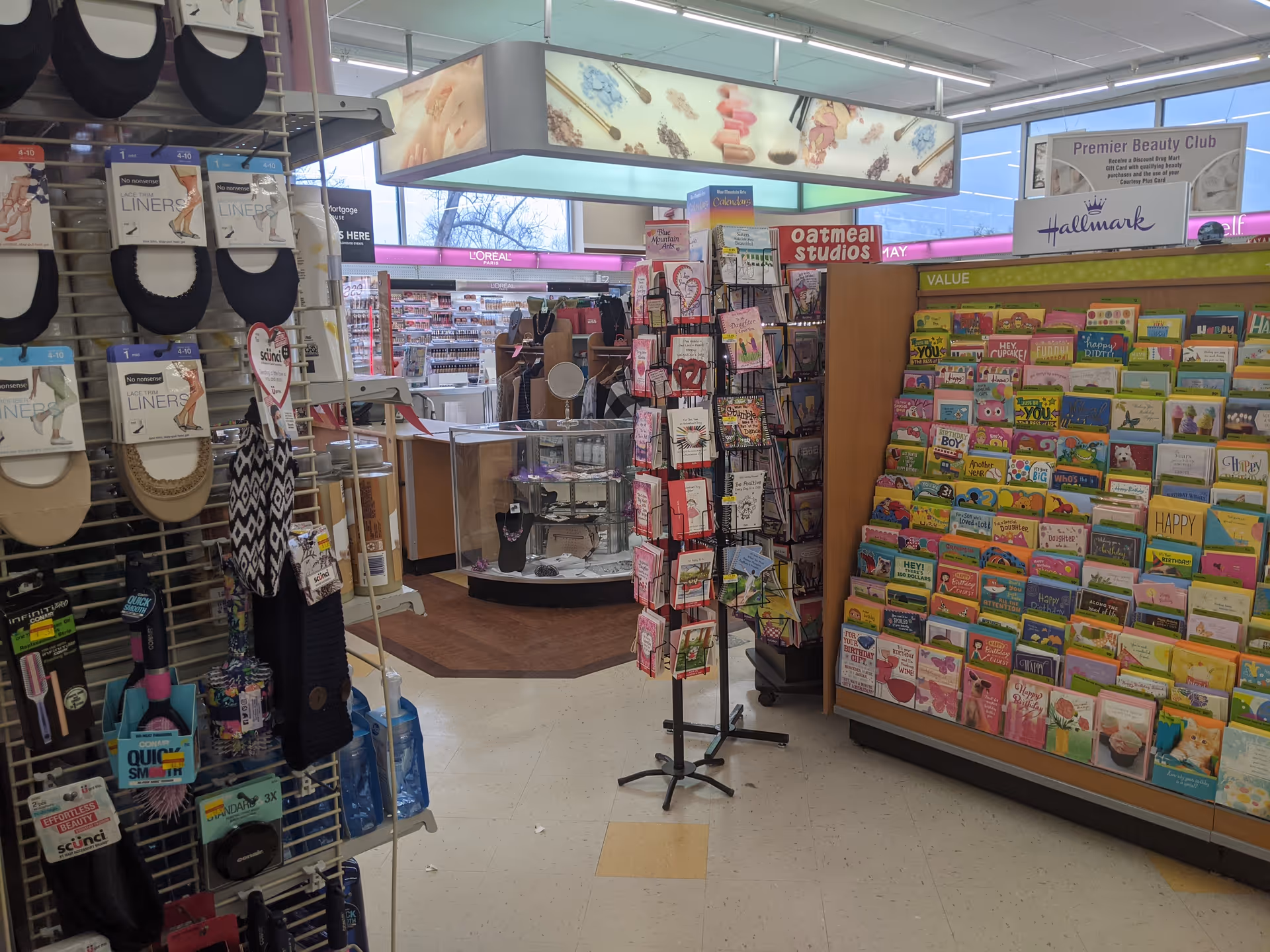 Inside Discount Drug Mart: greeting cards, accessories, and beauty products on shelves.
