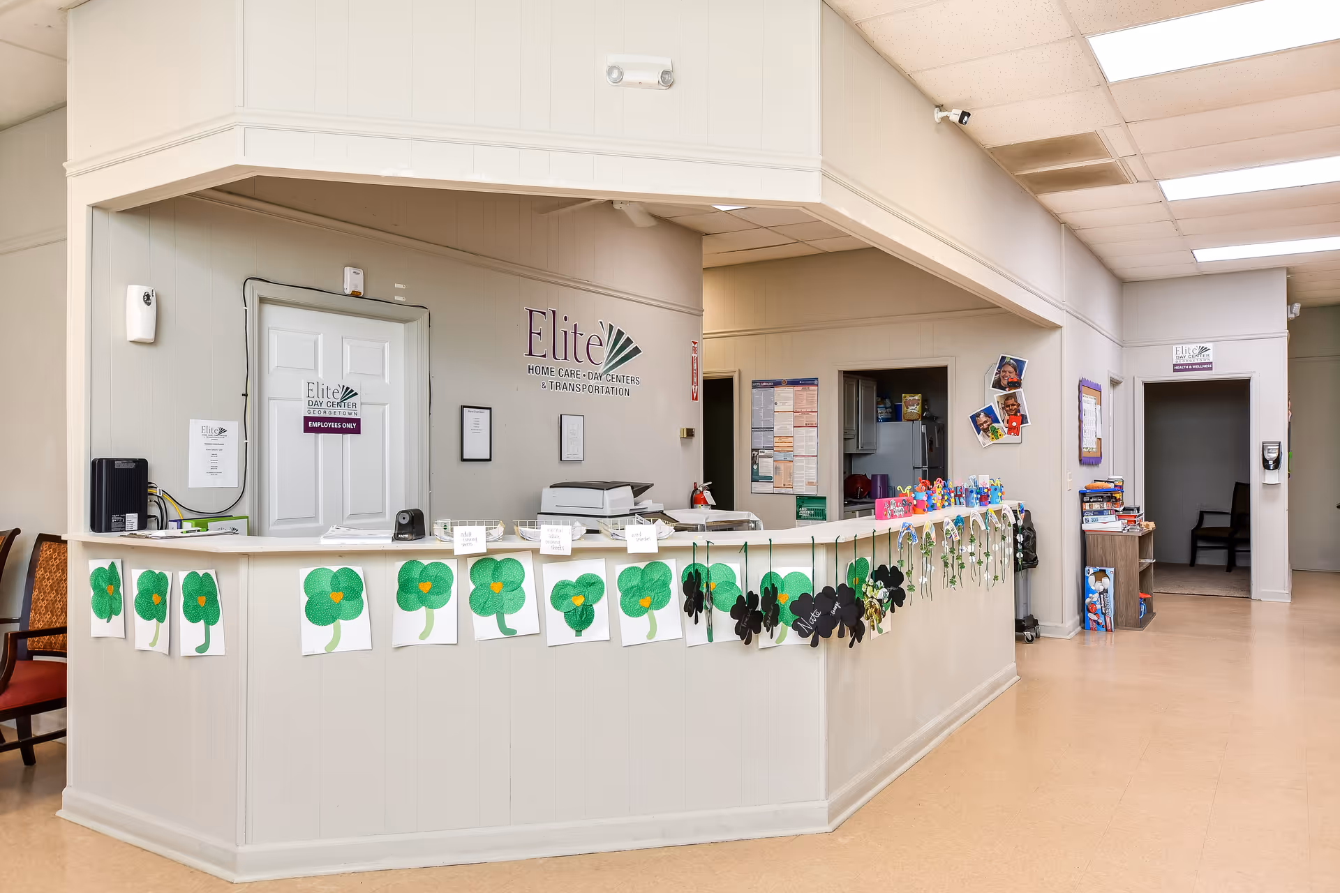 Reception desk in Elite Day Center lobby with green shamrock decorations.